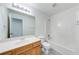 Neat bathroom with modern vanity, mirror, white walls, and shower-tub combo at 1265 Kelly Nelson Dr, Lawrenceville, GA 30043
