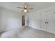 Light and airy bedroom featuring carpet, ceiling fan, and a closet with bi-fold doors at 1265 Kelly Nelson Dr, Lawrenceville, GA 30043
