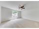 Spacious bedroom with a large window that fills the room with light and a modern ceiling fan at 1265 Kelly Nelson Dr, Lawrenceville, GA 30043