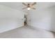 Neutral bedroom featuring carpet flooring, ceiling fan, and adjacent doorway to other rooms at 1265 Kelly Nelson Dr, Lawrenceville, GA 30043