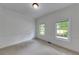 Cozy bedroom with plush carpeting, crown molding, and plenty of natural light from two windows at 1265 Kelly Nelson Dr, Lawrenceville, GA 30043