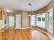 Bright dining area featuring hardwood floors, large windows, and classic chandelier at 1265 Kelly Nelson Dr, Lawrenceville, GA 30043