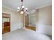 Cozy dining room with chandelier lighting and a doorway view into the adjacent kitchen at 1265 Kelly Nelson Dr, Lawrenceville, GA 30043