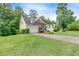 Exterior view of the home highlighting the front yard, driveway, and well-maintained landscaping at 1265 Kelly Nelson Dr, Lawrenceville, GA 30043