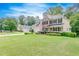 Two story home featuring a well-manicured lawn, driveway, and traditional architectural details at 1265 Kelly Nelson Dr, Lawrenceville, GA 30043