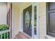 Close-up of front door with decorative glass, sidelights, and brick steps at 1265 Kelly Nelson Dr, Lawrenceville, GA 30043