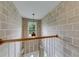 Unique wallpapered hallway with a modern light fixture and hardwood railing at 1265 Kelly Nelson Dr, Lawrenceville, GA 30043