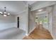 Hallway with hardwood floors, brick accent wall, and views into the dining room and other living spaces at 1265 Kelly Nelson Dr, Lawrenceville, GA 30043