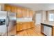 Kitchen featuring stainless steel appliances, wooden cabinets, and a bright and open layout at 1265 Kelly Nelson Dr, Lawrenceville, GA 30043