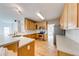 Well-lit kitchen featuring wooden cabinets, modern appliances, and a breakfast bar area at 1265 Kelly Nelson Dr, Lawrenceville, GA 30043