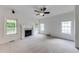 Spacious living room with fireplace, ceiling fan and bright natural light from multiple windows at 1265 Kelly Nelson Dr, Lawrenceville, GA 30043