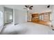 Open concept living room with ceiling fan, hardwood floors and view into the kitchen area at 1265 Kelly Nelson Dr, Lawrenceville, GA 30043