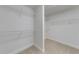 Bright walk-in closet featuring multiple tiers of shelving for optimized storage and organization at 1265 Kelly Nelson Dr, Lawrenceville, GA 30043