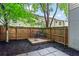 Private fenced backyard features a charming deck and stone patio area at 1271 Ponti Nw Mews # 92, Atlanta, GA 30318