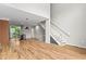 Expansive living area with hardwood floors, a modern staircase, and access to the kitchen at 1271 Ponti Nw Mews # 92, Atlanta, GA 30318