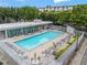 Large community pool surrounded by ample seating and lush landscaping at 1271 Ponti Nw Mews # 92, Atlanta, GA 30318