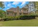 Expansive backyard view of a home featuring mature landscaping, and a large deck at 1605 Little Lisa Ln, Snellville, GA 30078