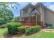 The backyard features a spacious wood deck with a sunshade awning, and manicured hedges bordering the lawn at 1605 Little Lisa Ln, Snellville, GA 30078