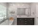 Bright bathroom featuring a soaking tub under a window and an elegant double sink vanity at 1605 Little Lisa Ln, Snellville, GA 30078