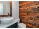 Stylish powder room featuring wood accent wall, modern vanity and vessel sink at 1605 Little Lisa Ln, Snellville, GA 30078