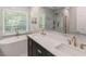 Luxurious bathroom featuring a soaking tub, double vanity with gold faucets, and a marble tiled shower at 1605 Little Lisa Ln, Snellville, GA 30078