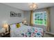 Cozy bedroom featuring a window with curtains and two bedside lamps on either side of the bed at 1605 Little Lisa Ln, Snellville, GA 30078
