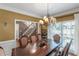 Elegant dining room featuring a chandelier, wainscoting, and large windows at 1605 Little Lisa Ln, Snellville, GA 30078