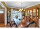 Formal dining room with a large table, hutch, and natural light at 1605 Little Lisa Ln, Snellville, GA 30078