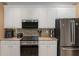 Well-equipped kitchen with modern appliances, granite countertops, and white cabinetry at 1605 Little Lisa Ln, Snellville, GA 30078