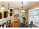 Eat-in kitchen with a table and chairs next to the windows, and barstool seating at the counter at 1605 Little Lisa Ln, Snellville, GA 30078