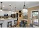 Sunlit kitchen with granite countertops, white cabinets and stainless steel appliances at 1605 Little Lisa Ln, Snellville, GA 30078