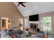 Cozy living room with a fireplace, vaulted ceiling, and comfortable seating at 1605 Little Lisa Ln, Snellville, GA 30078