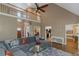 Open-concept living room with view of staircase, kitchen, and dining room at 1605 Little Lisa Ln, Snellville, GA 30078