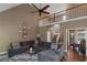 Bright living room with high ceilings, open staircase, and a gray sectional sofa at 1605 Little Lisa Ln, Snellville, GA 30078