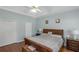 Serene main bedroom with light blue walls, hardwood floors, tray ceiling, closet and furnishings at 1605 Little Lisa Ln, Snellville, GA 30078
