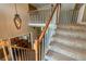Elegant staircase with wooden railing and chandelier leading to the upper level and dining area at 1605 Little Lisa Ln, Snellville, GA 30078