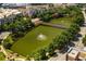Aerial view of a large pond featuring fountains, a walking bridge, and mature trees near the condominiums at 390 17Th Nw St # 4055, Atlanta, GA 30363