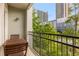 Relaxing balcony space with wood table set and overlooks greenery and city buildings in the background at 390 17Th Nw St # 4055, Atlanta, GA 30363