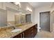 This bathroom features a double sink vanity with granite countertop, modern fixtures, and a walk-in shower at 390 17Th Nw St # 4055, Atlanta, GA 30363