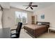 This cozy bedroom offers natural light, a ceiling fan, simple furnishings, and views of the city skyline at 390 17Th Nw St # 4055, Atlanta, GA 30363
