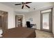 Comfortable bedroom with a view of the balcony, ceiling fan, and easy access to other rooms within the condo at 390 17Th Nw St # 4055, Atlanta, GA 30363