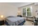 Cozy bedroom with a large window, providing ample natural light and a peaceful ambiance at 390 17Th Nw St # 4055, Atlanta, GA 30363