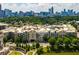 Exterior daytime shot of a condo building in a lush urban area with the Atlanta skyline in the background at 390 17Th Nw St # 4055, Atlanta, GA 30363