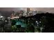 Night skyline view of the city with residential area in the foreground. Street lamps provide ambient lighting at 390 17Th Nw St # 4055, Atlanta, GA 30363