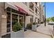 Attractive condo building featuring planters, a red awning, and clear signage for prospective residents at 390 17Th Nw St # 4055, Atlanta, GA 30363