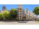 Attractive multi-story condo building with a brick and tan facade, balconies, and street-level scooter parking at 390 17Th Nw St # 4055, Atlanta, GA 30363