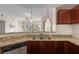 Open kitchen with granite countertops and stainless steel dishwasher overlooks living area at 390 17Th Nw St # 4055, Atlanta, GA 30363