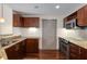 Modern kitchen with stainless steel appliances, granite counters, and dark wood cabinetry at 390 17Th Nw St # 4055, Atlanta, GA 30363