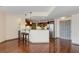 Open kitchen with stainless steel appliances, granite counters, breakfast bar, and hardwood floors at 390 17Th Nw St # 4055, Atlanta, GA 30363