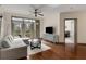 Bright living room featuring hardwood floors, modern decor, and balcony access with a city view at 390 17Th Nw St # 4055, Atlanta, GA 30363